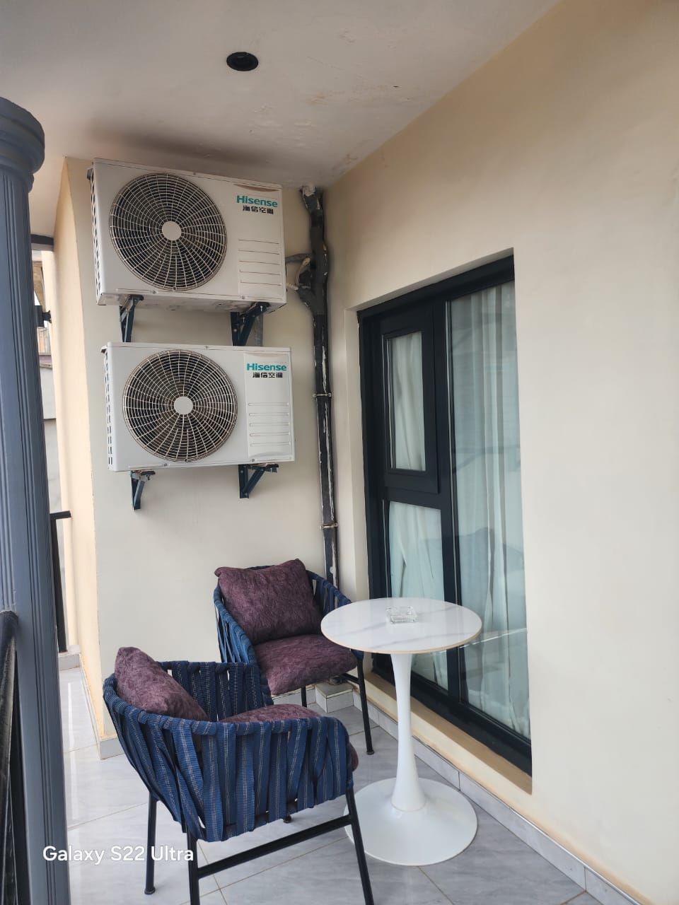 Balcony with bistro table and woven armchairs