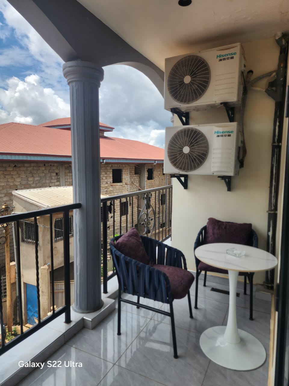 Balcony lounge corner with columns and open view