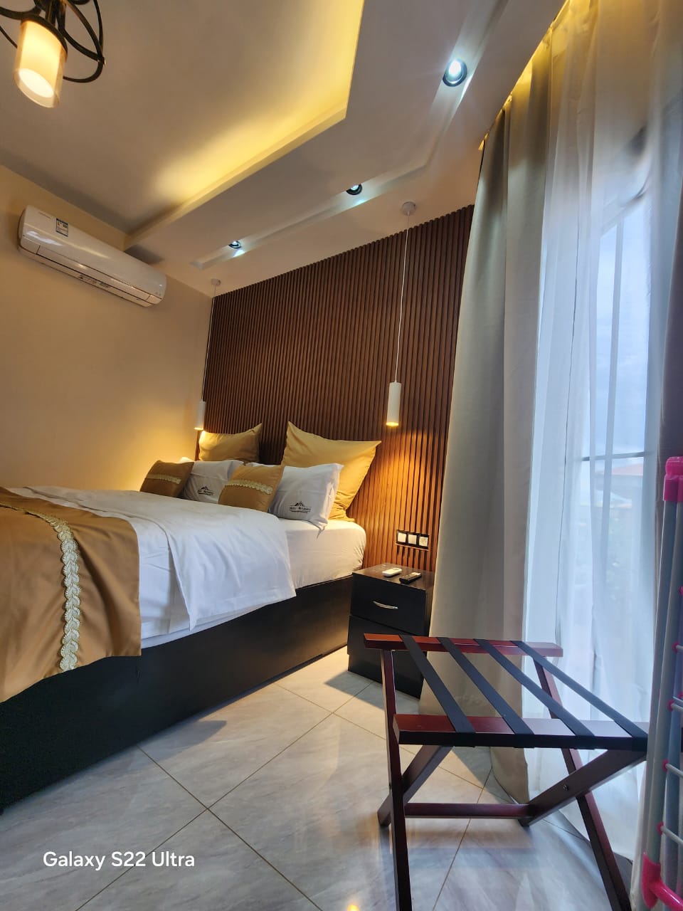 Bedroom with wooden headboard and pendant lights