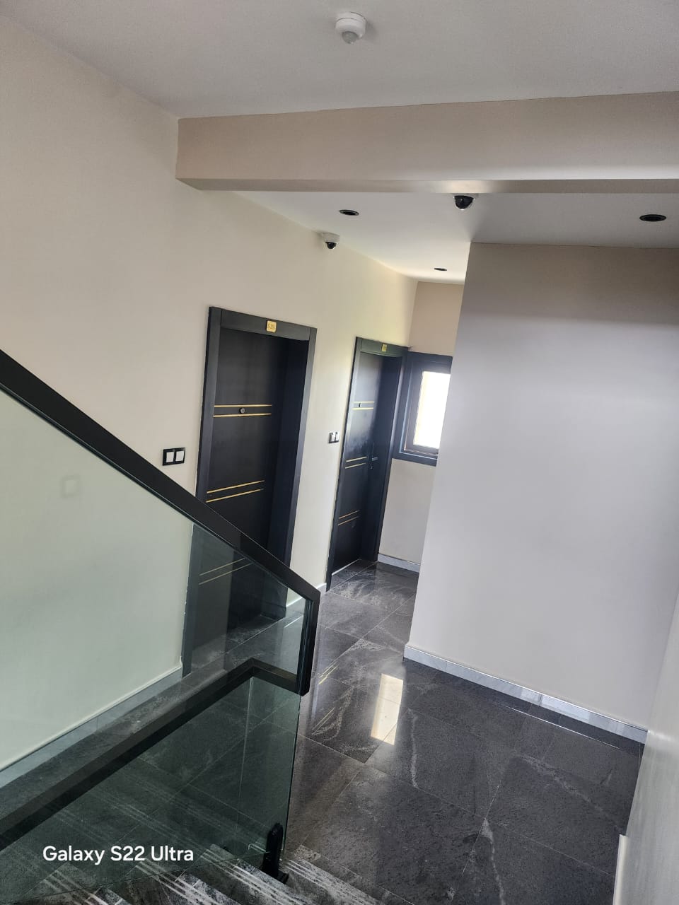 Landing with black doors and gold trim